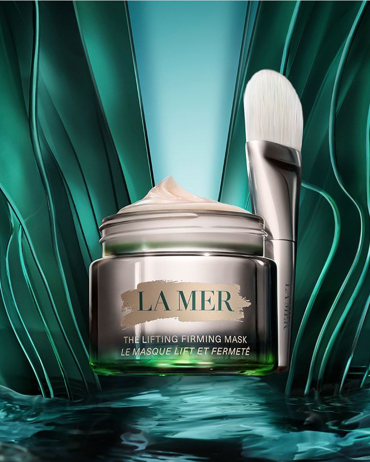 The Lifting Firming Mask nested in aqua marine waves, in front of a curved, dynamic background